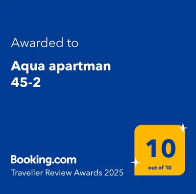 a yellow sign that reads awarded to aquaarmaarmaarma at Aqua apartman 45-2 in Jagodina