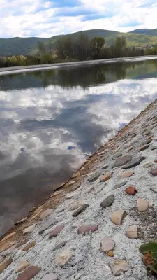a large body of water with rocks in front of it at Seosko turisticko domacinstvo Nikolic-Zivkovic selo Ljubatovica in Čiflik