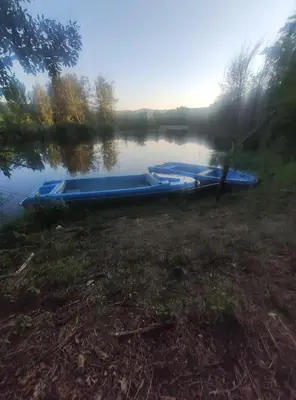 two boats sitting on the shore of a lake at Seosko turisticko domacinstvo Nikolic-Zivkovic selo Ljubatovica in Čiflik