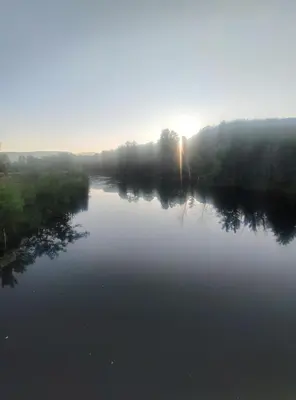 a river with the sun reflecting on the water at Seosko turisticko domacinstvo Nikolic-Zivkovic selo Ljubatovica in Čiflik