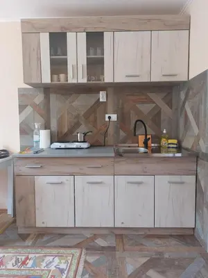 a kitchen with white cabinets and a sink at Dukat 2 in Soko Banja