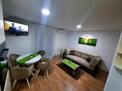 a living room with a couch and a table at Apartman Taša Vrnjačka Banja in Vrnjci