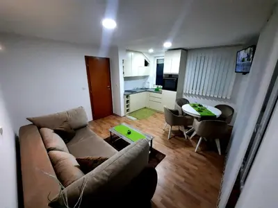 a living room with a couch and a table at Apartman Taša Vrnjačka Banja in Vrnjci