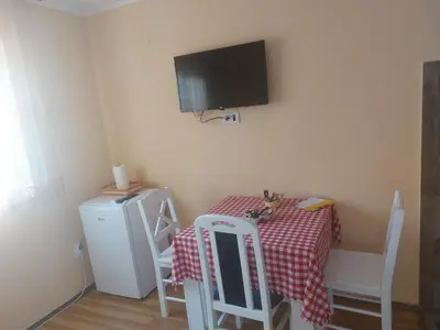 a small room with a table and a tv on the wall at Dukat 3 in Soko Banja