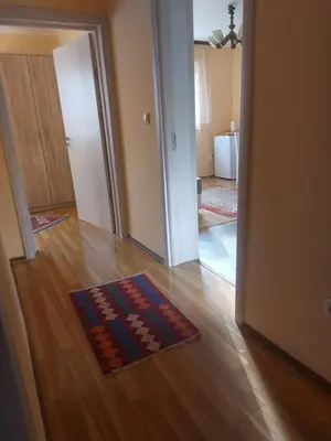 a living room with a rug on a wooden floor at Dukat 3 in Soko Banja