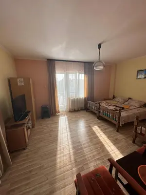 a room with a bed and a television in it at Apartments Božinović in Soko Banja