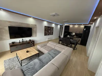 a living room with a couch and a table at Brasic Apartman in Zaječar