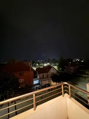 a view of a city at night at Brasic Apartman in Zaječar