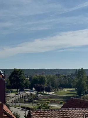 a view of a park with trees and buildings at Brasic Apartman in Zaječar