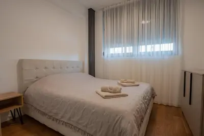 a bedroom with a bed with two towels on it at NOVA Apartmani in Kraljevo