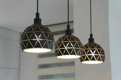 a group of three lights hanging from a ceiling at NOVA Apartmani in Kraljevo