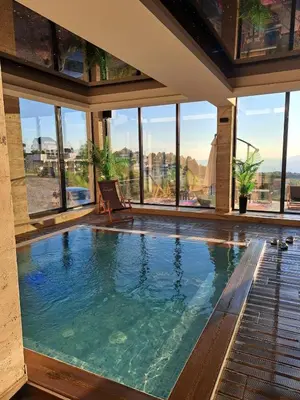 a swimming pool in a house with large windows at Mips Amadeus P85 in Cajetina