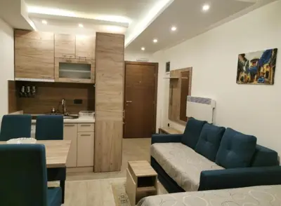 a living room with a couch and a kitchen at Mips Amadeus P85 in Cajetina