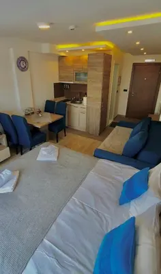 a large white bed in a room with a kitchen at Mips Amadeus P85 in Cajetina