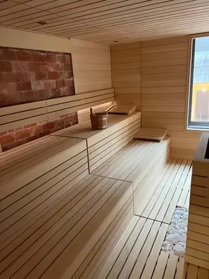 an empty sauna with wooden floors and a window at Rtanj Kopaonik Eco Resort & Spa in Kopaonik