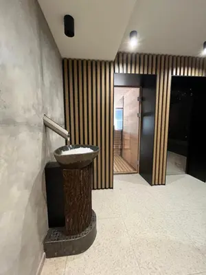 a bathroom with a sink in the middle of a room at Rtanj Kopaonik Eco Resort & Spa in Kopaonik