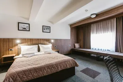 a hotel room with a bed and a window at Rtanj Kopaonik Eco Resort & Spa in Kopaonik