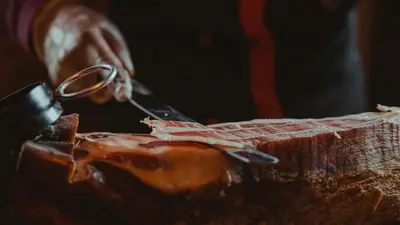 a person cutting a cake with a pair of scissors at Rtanj Kopaonik Eco Resort & Spa in Kopaonik