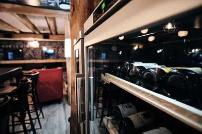 a room with bottles of wine in a restaurant at Rtanj Kopaonik Eco Resort & Spa in Kopaonik