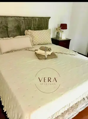a white bed with a yara logo on it at VERA apartman in Zaječar