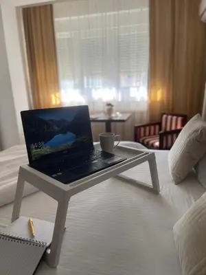 a laptop computer sitting on a table in a hotel room at VERA apartman in Zaječar
