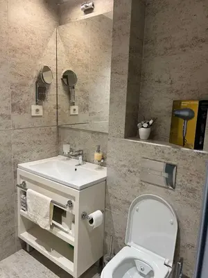 a bathroom with a white toilet and a sink at Zepterme Apartman 605 Premium in Vrnjačka Banja