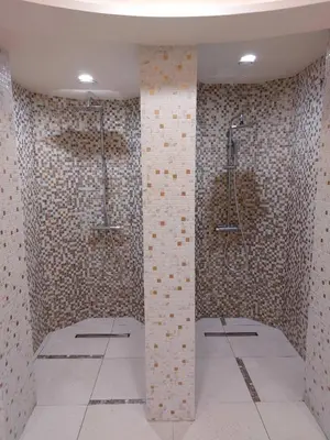 a bathroom with a shower and a tile wall at Zepterme Apartman 605 Premium in Vrnjačka Banja