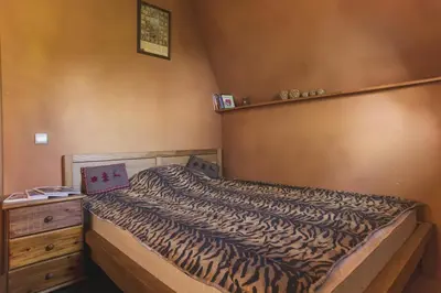 a bedroom with a bed and a wooden dresser at Guesthouse Šejn in Kopaonik
