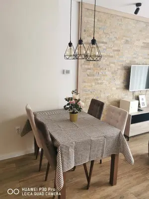 a dining room table with a table cloth and chairs at Bela Idila - Kopaonik in Kopaonik