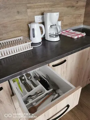 a kitchen counter with a drawer filled with kitchen utensils at Bela Idila - Kopaonik in Kopaonik