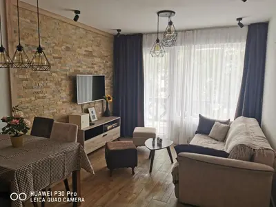 a living room with a couch and a table at Bela Idila - Kopaonik in Kopaonik