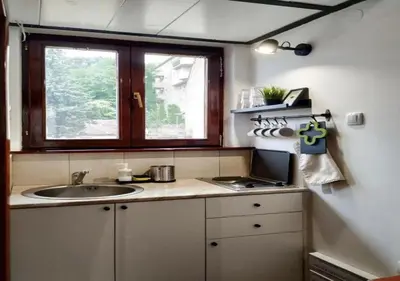 a small kitchen with a sink and a window at Vrnjačka Banja - Apartman Zen in Vrnjačka Banja