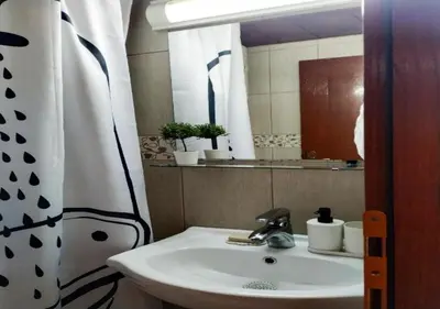 a bathroom with a sink and a mirror at Vrnjačka Banja - Apartman Zen in Vrnjačka Banja