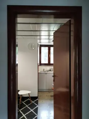 an open door to a kitchen with a table at Vrnjačka Banja - Apartman Zen in Vrnjačka Banja
