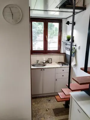 a kitchen with a sink and a clock on the wall at Vrnjačka Banja - Apartman Zen in Vrnjačka Banja