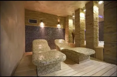 a room with two chairs and a table at Apartment 111 at Zoned Apart Hotel & Spa - Apartman 111 u hotelu Zoned in Kopaonik