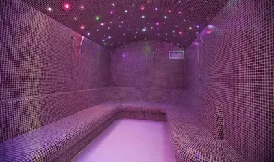 a purple room with a tub in a room with lights at Apartment 111 at Zoned Apart Hotel & Spa - Apartman 111 u hotelu Zoned in Kopaonik
