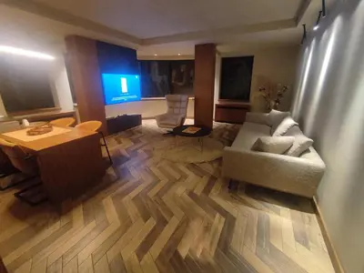 a living room with a couch and a table at Floid in Niš
