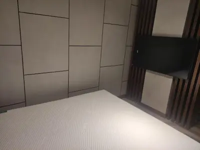 a room with a bed and a flat screen tv at Floid in Niš