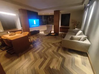 a living room with a couch and a table at Floid in Niš