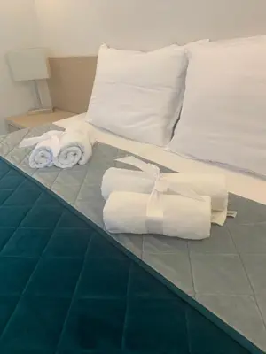a bed with towels and pillows on it at Garni hotel Vir in Vrnjačka Banja