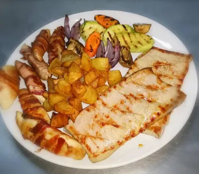 a white plate of food with fish and potatoes at Garni hotel Vir in Vrnjačka Banja