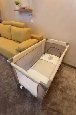 a hospital bed with a couch in a room at Apartments Andrejic in Kopaonik