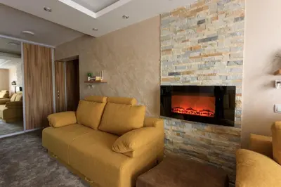 a living room with a couch and a fireplace at Apartments Andrejic in Kopaonik