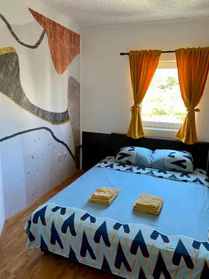 a bedroom with a bed with two towels on it at City view & pool apartment 2 in Niš