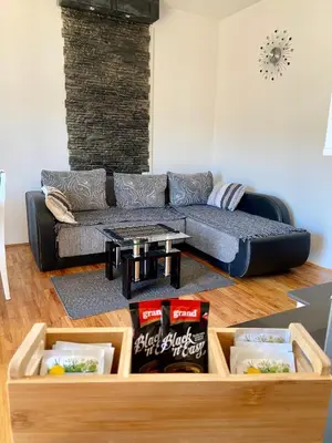 a living room with a couch and a table at City view & pool apartment 2 in Niš
