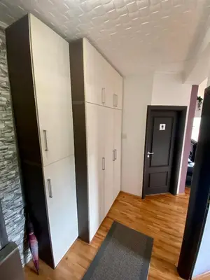a room with white cabinets and a black door at City view & pool apartment 2 in Niš