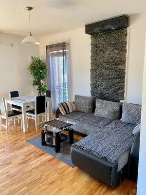 a living room with a couch and a table at City view & pool apartment 2 in Niš