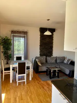 a living room with a couch and a table at City view & pool apartment 2 in Niš