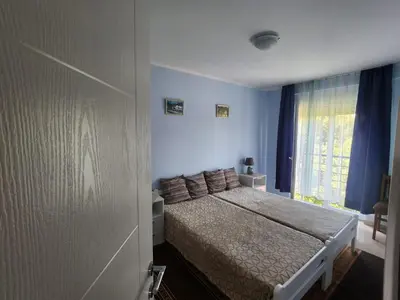 a bedroom with a bed and a window at Apartman Goca in Vrnjačka Banja